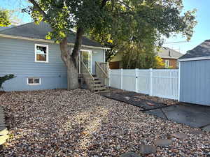 Rear view of house with a gate and roof with shingles