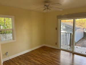 Main Floor Bedroom 2 with wood finished floors and ceiling fan