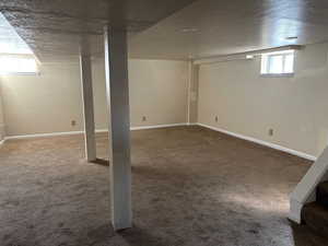 Below grade area featuring carpet flooring and baseboards