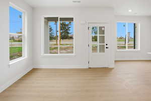 Entryway with baseboards and wood finished floors