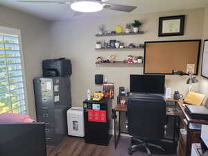 Office featuring dark wood-style flooring and ceiling fan