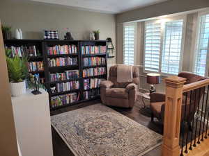 Sitting room with plenty of natural light and wood finished floors