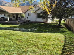 View of yard featuring a deck with mountain view
