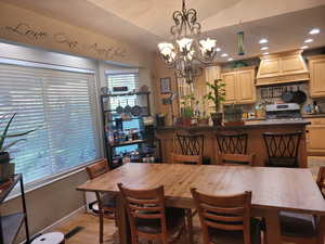 Dining area with recessed lighting, a chandelier, and light wood-style flooring