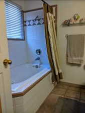 Bathroom with shower / bath combination with curtain and tile patterned flooring