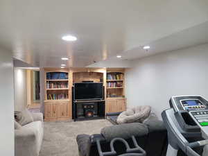 Living room with light colored carpet, recessed lighting, and a textured ceiling