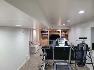 Exercise room with recessed lighting and carpet flooring