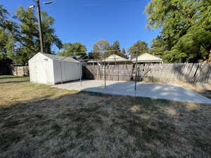 Fenced backyard with a storage shed