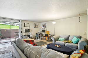 Living area featuring a textured ceiling