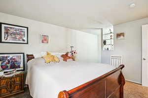 Bedroom featuring carpet floors and a textured ceiling