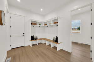 Mudroom featuring light wood finished floors and recessed lighting