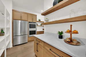Kitchen featuring open shelves, stainless steel appliances, recessed lighting, light stone countertops, and light wood-type flooring