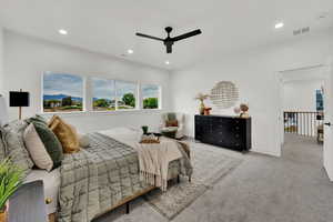 Carpeted bedroom featuring recessed lighting and a ceiling fan