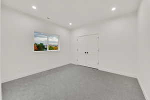 Unfurnished bedroom with carpet floors, recessed lighting, and a closet