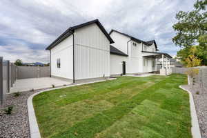 Rear view of property featuring a fenced backyard and a patio area
