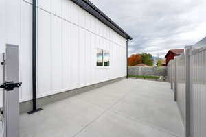 View of home's exterior featuring board and batten siding, a fenced backyard, and a patio
