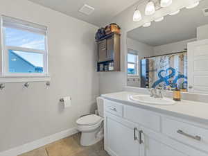 Full bath with vanity, light tile patterned flooring, and a shower with curtain