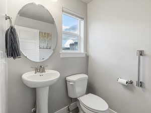 Bathroom featuring baseboards and toilet