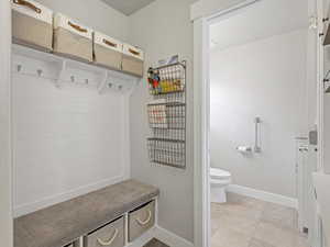 Mudroom with baseboards and light tile patterned floors