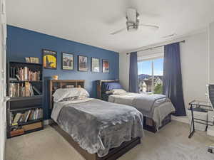 Carpeted bedroom with ceiling fan