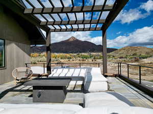 View of patio featuring outdoor lounge area, a mountain view, and a pergola