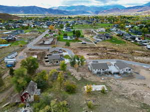 Aerial overview of property's location with mountains and nearby suburban area
