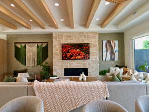 Living area featuring beamed ceiling, wallpapered walls, a fireplace, and recessed lighting
