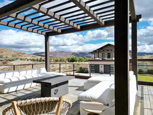 Balcony with an outdoor living space, a mountain view, and a pergola