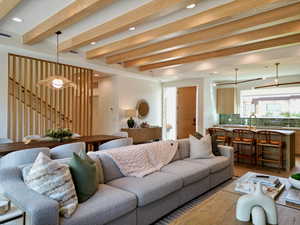 Living area featuring beamed ceiling, wood finished floors, and recessed lighting