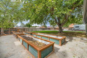 View of pool featuring a fenced backyard, a garden, and a patio