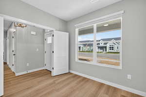 Spare room featuring baseboards and light wood-style floors