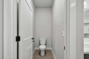 Bathroom featuring tile patterned flooring and baseboards