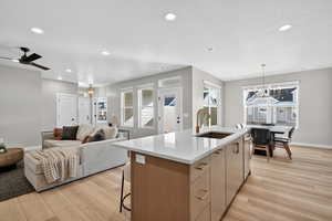 Kitchen with a chandelier, recessed lighting, open floor plan, a kitchen breakfast bar, and decorative light fixtures