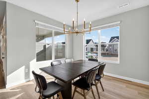 Dining room featuring a chandelier and light wood-style floors