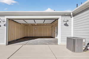Garage featuring concrete driveway