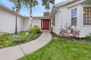 Doorway to property with a yard