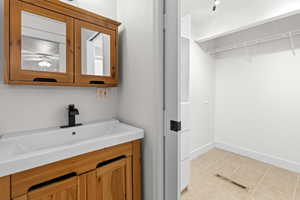 Primary Bathroom featuring vanity and light tile patterned flooring