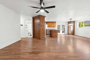 Unfurnished living room with light wood-style flooring, recessed lighting, french doors, beverage cooler, and ceiling fan