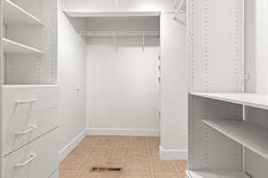 Walk in closet with light tile patterned flooring