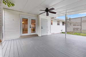 Deck featuring ceiling fan and french doors