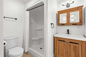 Primary Bathroom featuring vanity, a stall shower, and light tile patterned floors