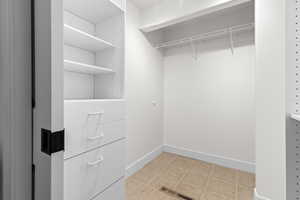 Spacious closet featuring light tile patterned floors