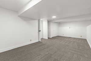 Finished below grade area with carpet floors and baseboards