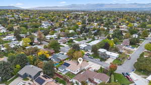 Aerial view of property's location featuring mountains and nearby suburban area