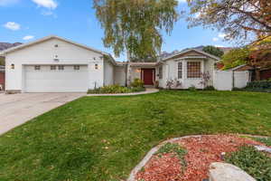 Ranch-style house featuring concrete driveway and a garage