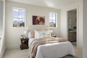 Upstairs Bedroom #2 featuring two windows with mountain scenery, neutral wall tones, and textured carpet flooring