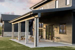 Covered concrete patio with stone-wrapped columns