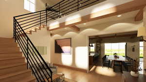 Staircase featuring wood finished floors, metal railings