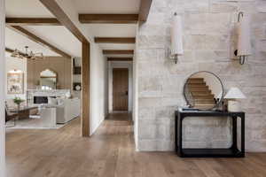 Stunning ceiling beams throughout main level along with floor to ceiling stone entry with sconces.