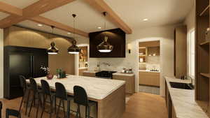 Kitchen with beam ceiling, two-tone cabinets, large island, pendant lighting, and black appliances
